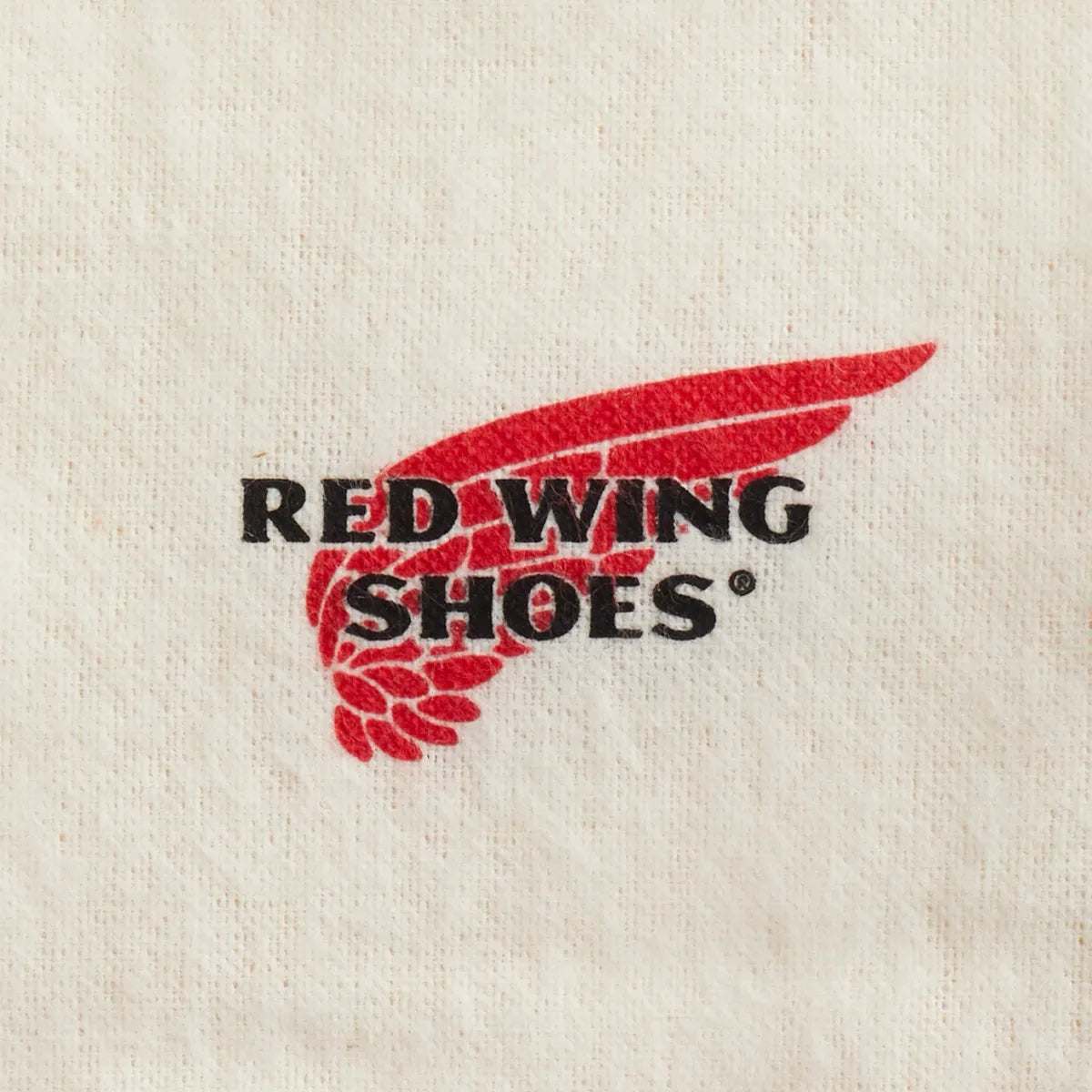 Red Wing Shoes branded boot care cloth showing logo detail on natural white fabric