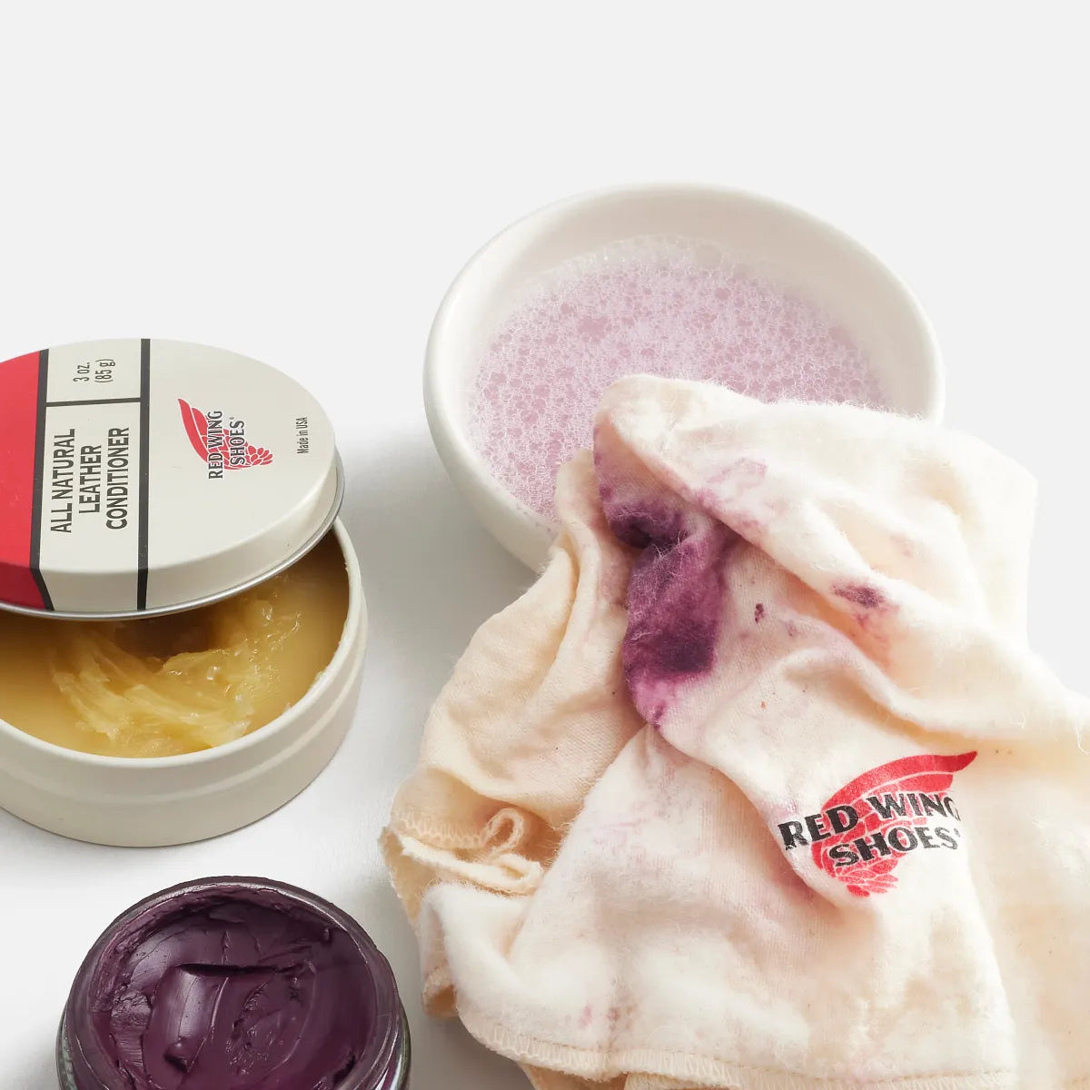 Red Wing Shoes boot care cloth displayed alongside leather conditioner and polish products
