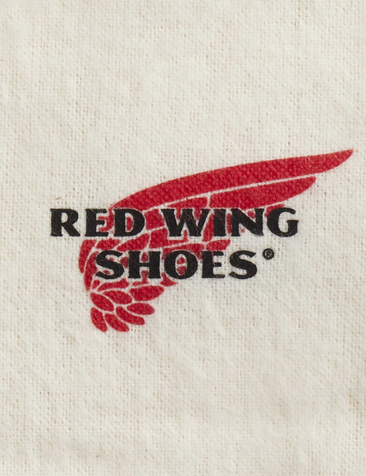 Red Wing Shoes logo printed on a white boot care cloth, detail close-up
