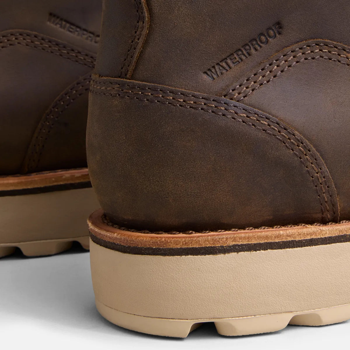 Close-up detail of waterproof leather work boot heel showing stitching and wedge sole