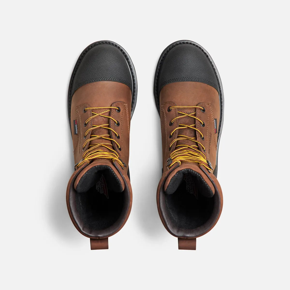 Top-down view of a pair of brown leather steel toe metguard work boots with yellow laces