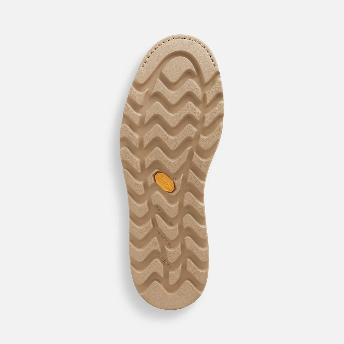 Bottom view of a Chelsea boot sole with wavy traction tread pattern and Vibram medallion