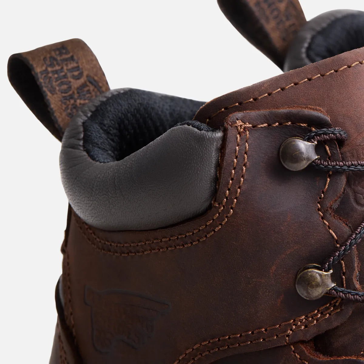 Close-up detail of Red Wing leather boot heel collar, laces, and pull tab