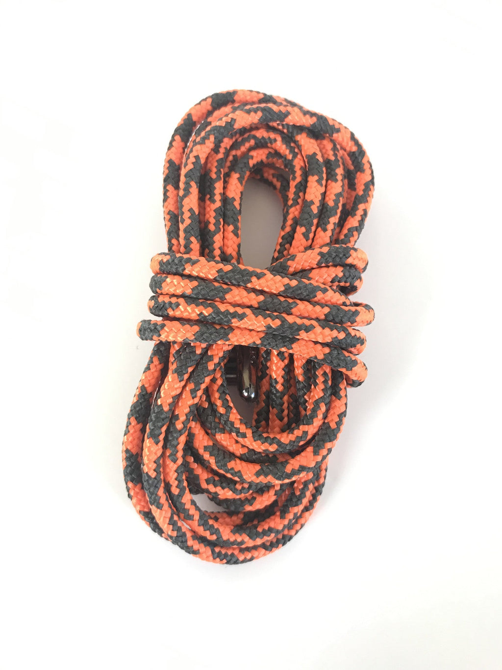 Coiled orange and black patterned braided shoelaces with metal aglets on white background