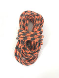 Coiled orange and black patterned braided shoelaces with metal aglets on white background