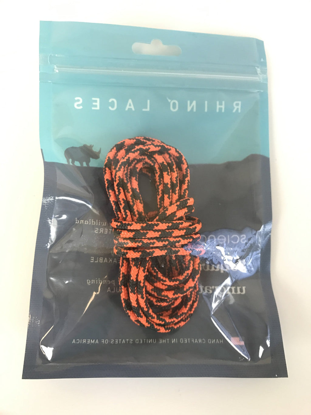 Rhino Laces coiled shoelaces in orange and black pattern shown in branded packaging