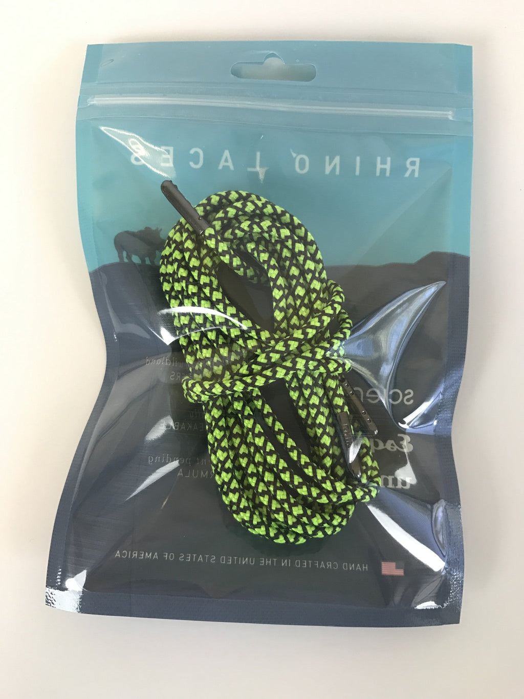 Rhino Laces shoelaces in neon green and black pattern coiled inside branded packaging