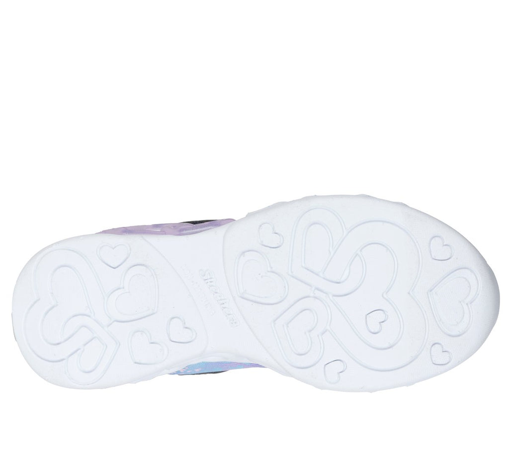 Bottom sole view of girls Skechers sneaker with heart-shaped tread pattern