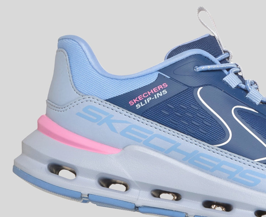 Close-up detail of Skechers Slip-Ins girls sneaker heel showing navy and light blue upper