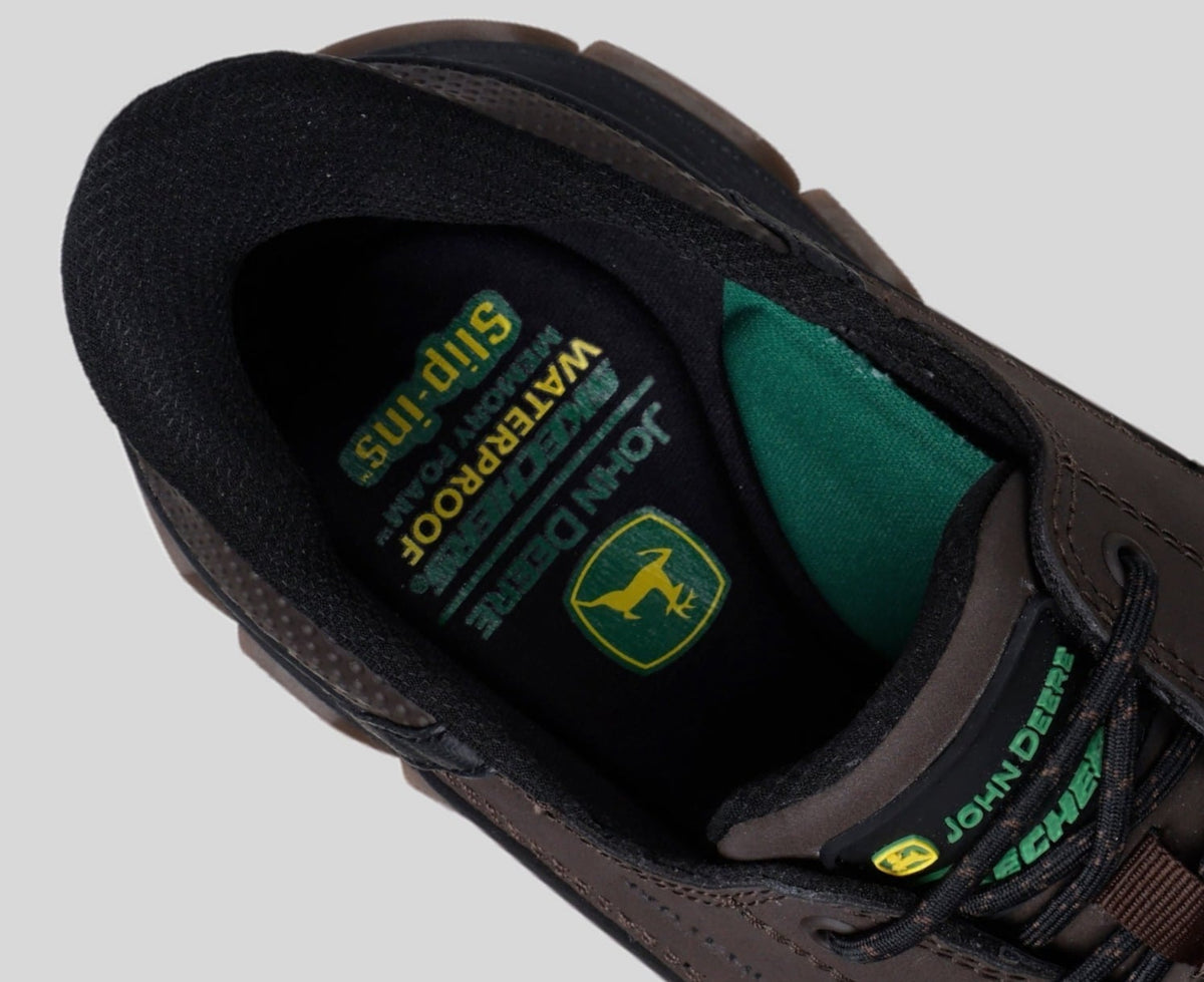 Close-up interior view of John Deere Skechers Slip-ins shoe showing insole and tongue branding