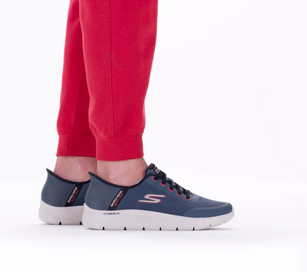 Skechers GO WALK Flex slip-on sneakers worn with red jogger pants, rear angle view