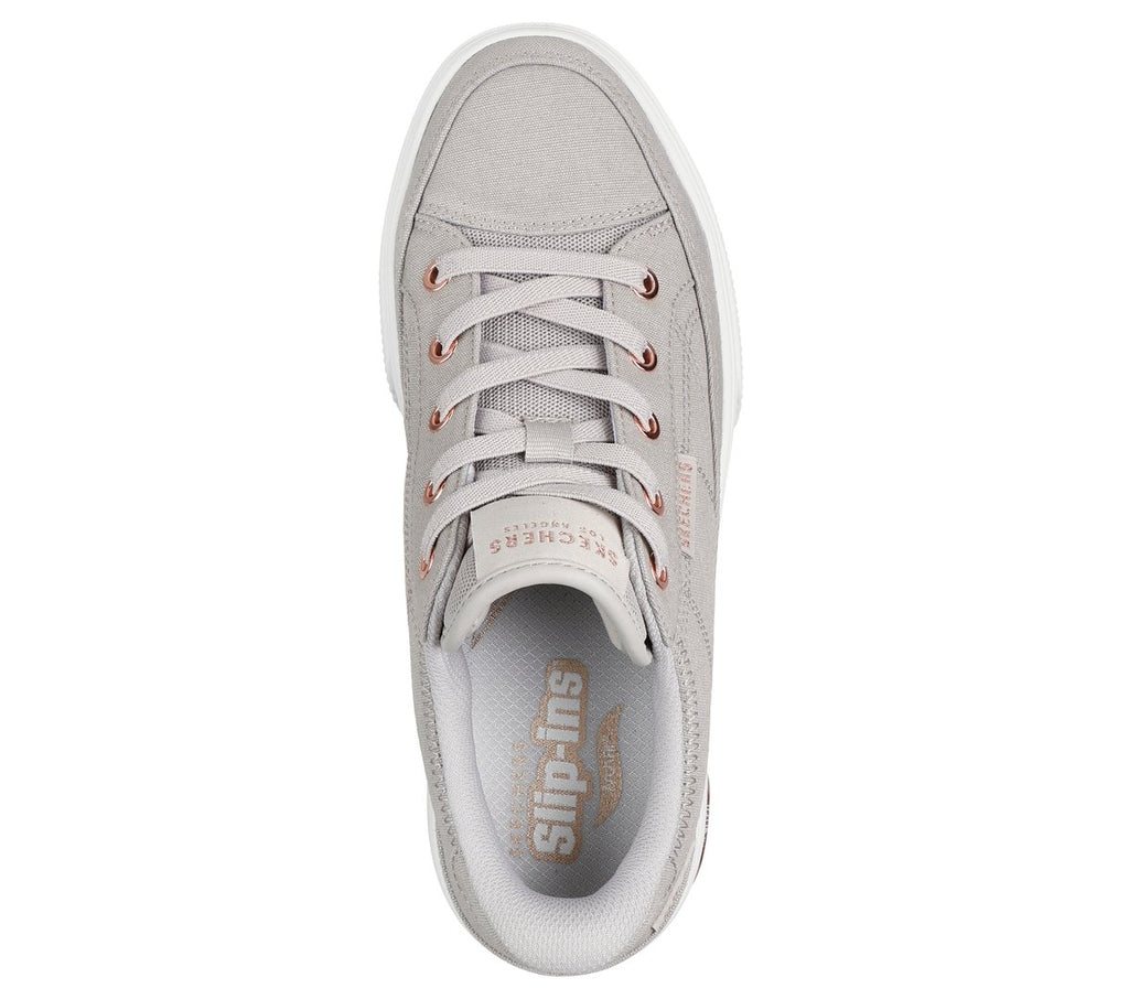 Top-down view of a lace-up sneaker with rose gold eyelets and Slip-ins insole