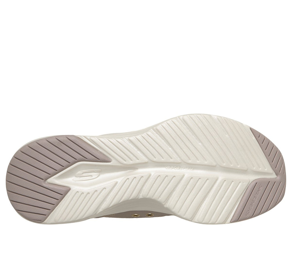 Bottom sole view of Skechers womens slip-in sneaker showing traction pattern and logo