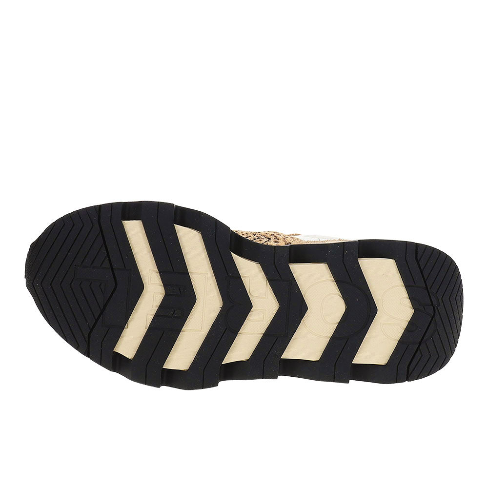 Bottom sole view of women's sneaker showing black rubber outsole with chevron traction pattern