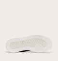 Bottom sole view of Sorel sneaker showing chevron tread pattern and brand logo