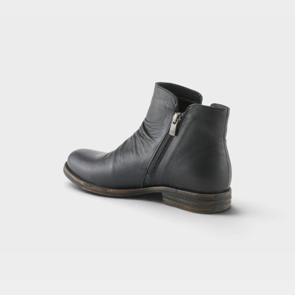 Women's leather ankle boot with side zipper closure and distressed sole, rear angle view