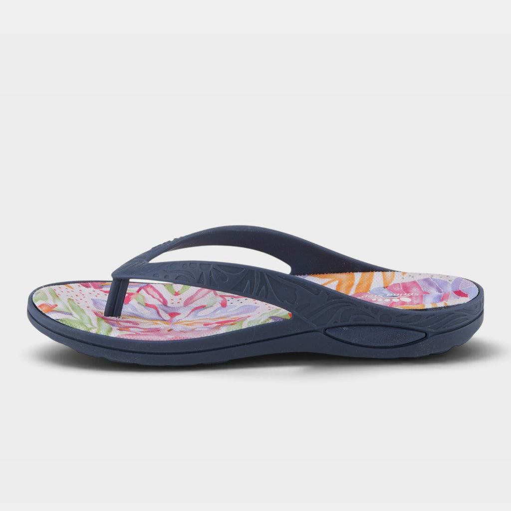 Women's flip flop sandal with navy straps and colorful tropical floral footbed, side view