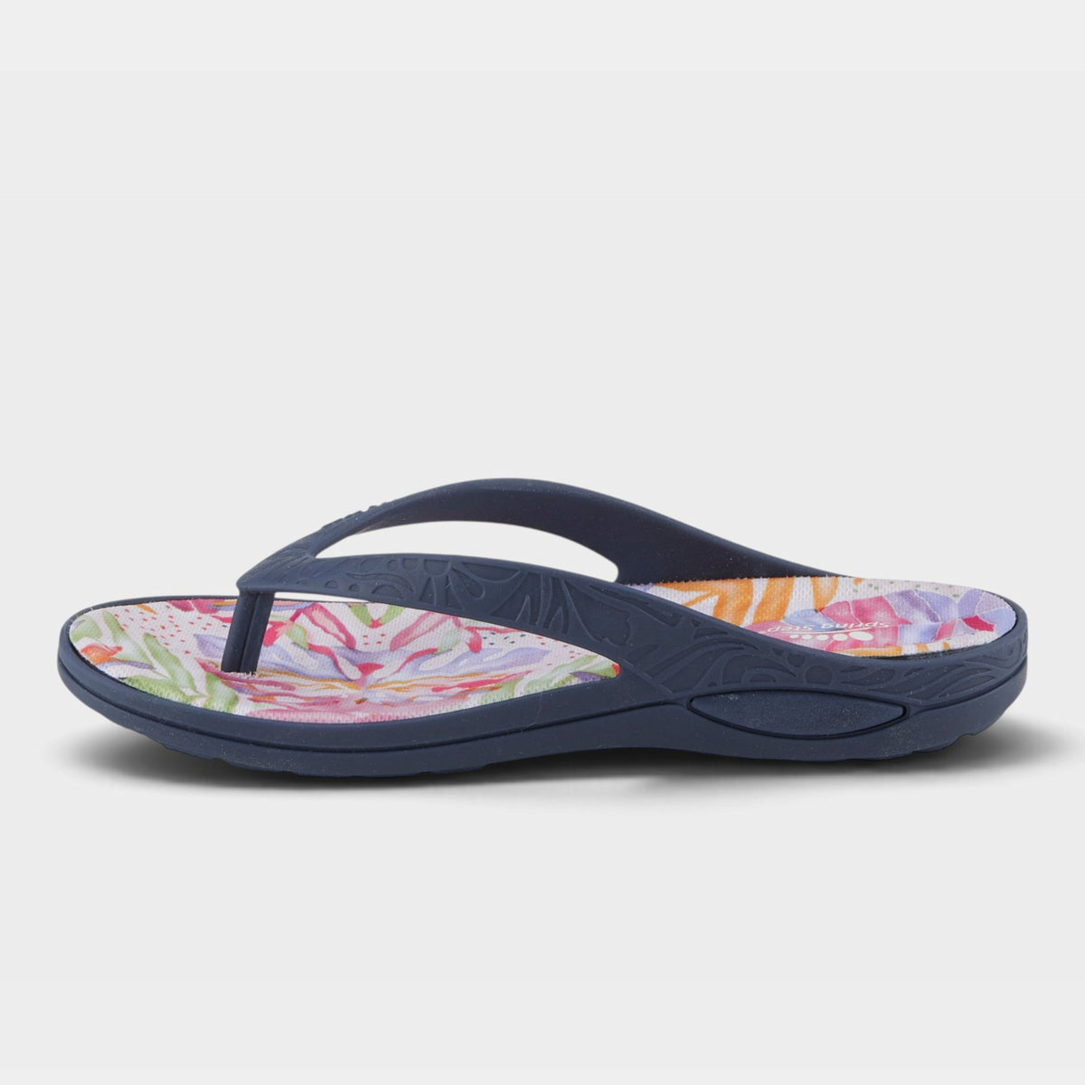 Women's flip flop sandal with navy straps and colorful tropical floral footbed, side view