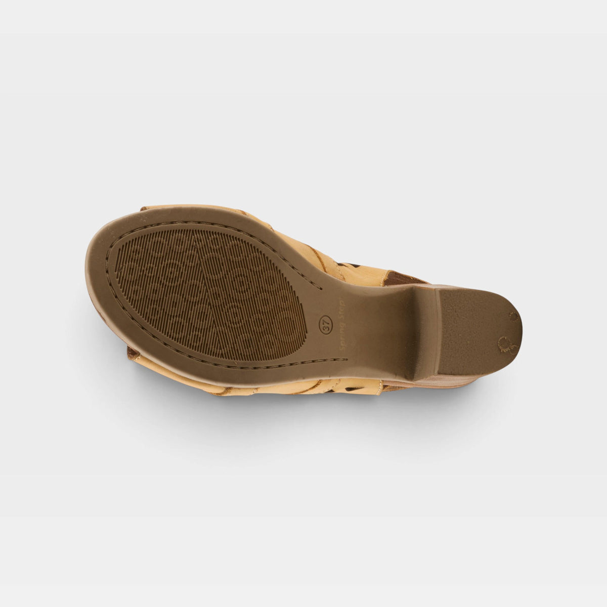 Bottom sole view of a tan leather wedge sandal showing textured rubber outsole and heel