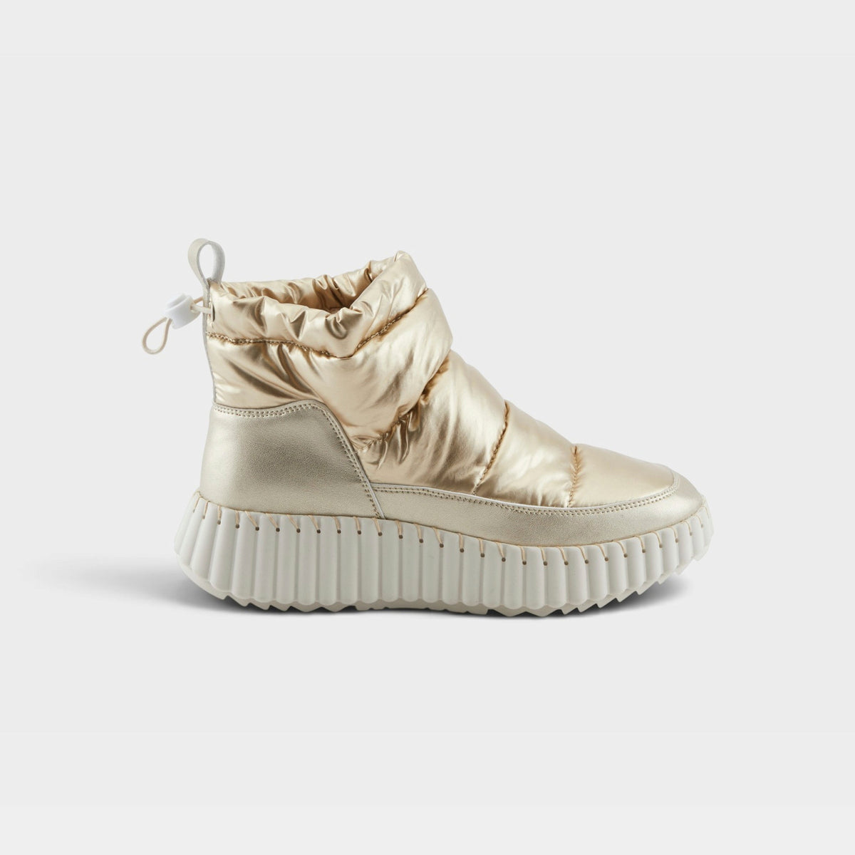 Women's metallic gold quilted puffer ankle boot with chunky white ribbed sole