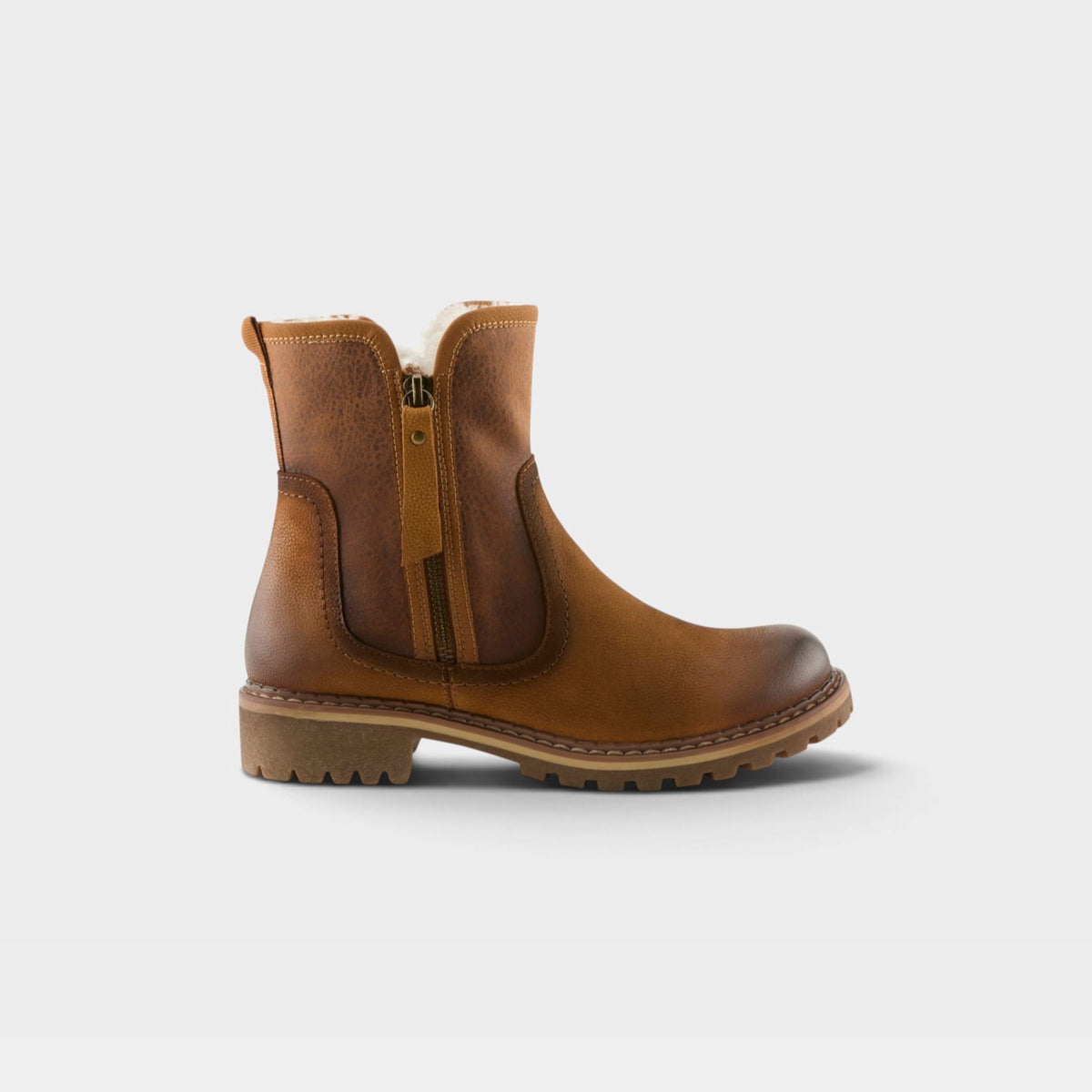 Women's ankle boot with shearling lining, side zipper, and lug sole in warm tan leather