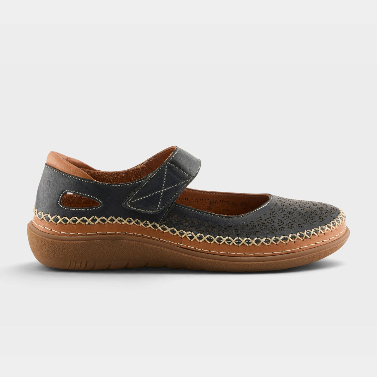 Women's Mary Jane flat with velcro strap, perforated toe, and tan rubber sole