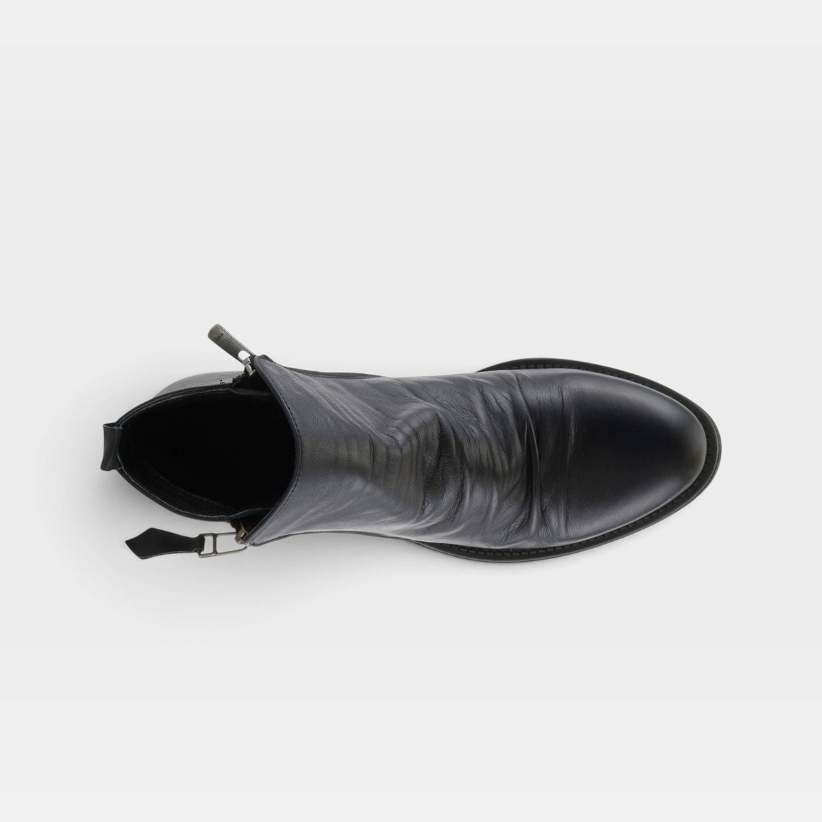 Top-down view of a black leather ankle boot with zip closure and rounded toe