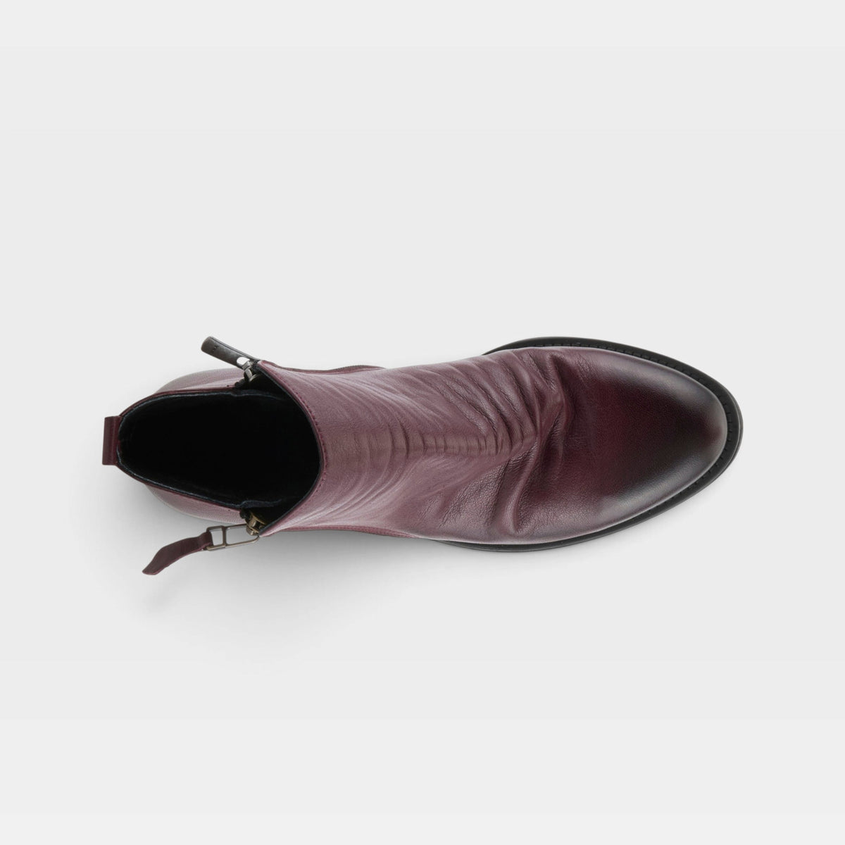 Top-down view of a leather ankle boot with side zipper and pointed toe