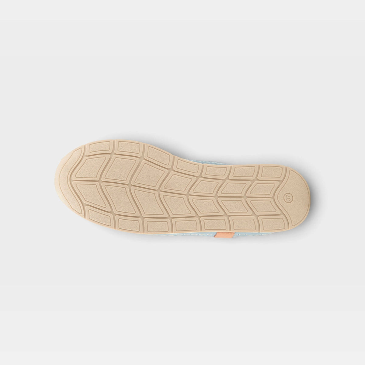 Bottom sole view of a women's casual shoe showing diamond-patterned tread and peach heel tab