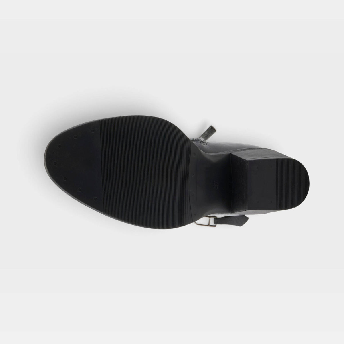 Bottom sole view of a black block-heel boot with textured rubber outsole and ankle buckle strap