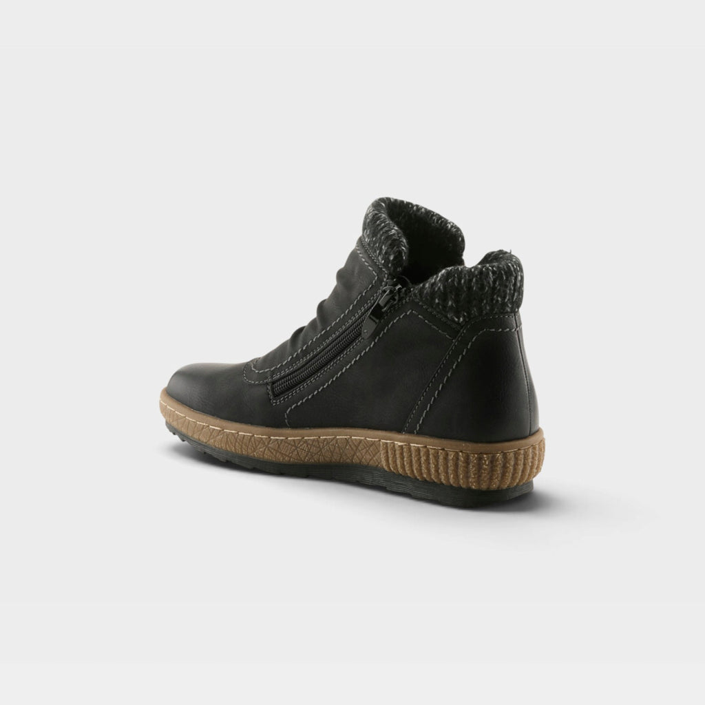 Back view of a black ankle boot with side zipper, knit collar, and tan rubber sole
