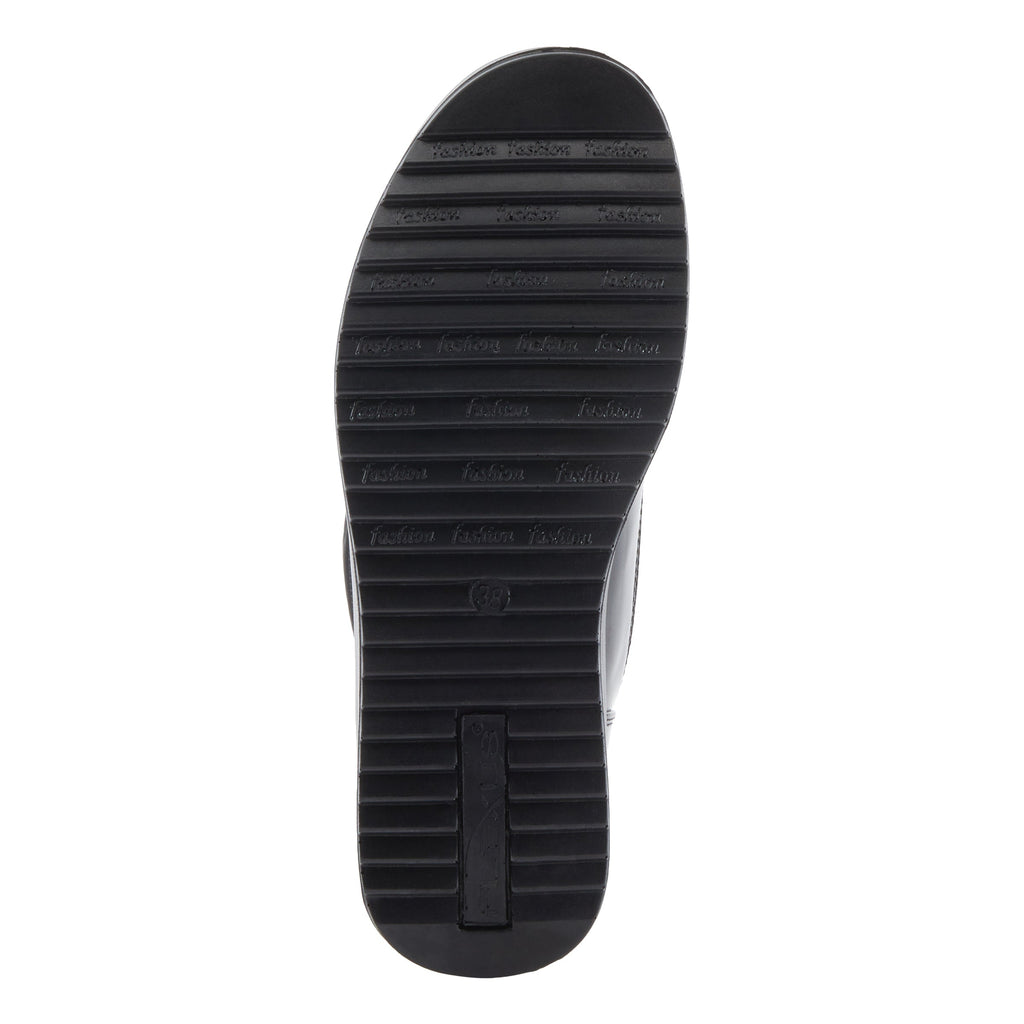 Bottom sole view of a women's shoe with ridged tread pattern and fashion branding