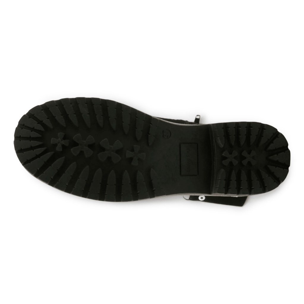 Bottom sole view of women's chunky lug-tread boot with buckle strap detail
