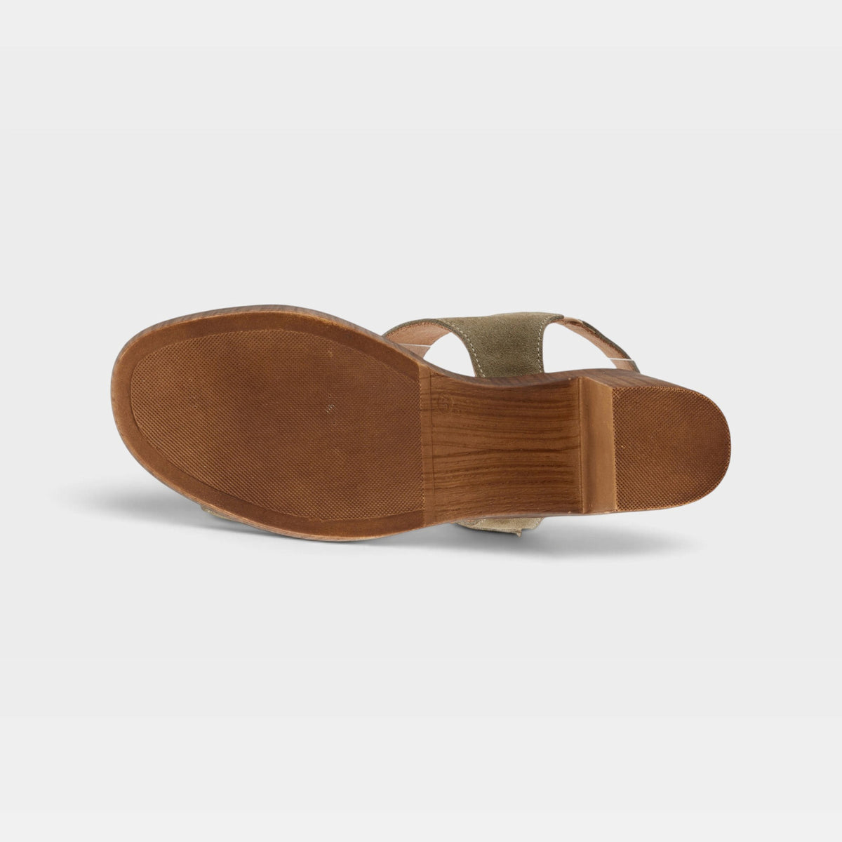 Bottom sole view of a women's wedge sandal with rubber outsole and wooden heel