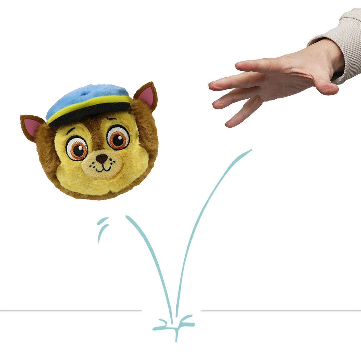 PAW Patrol Chase plush bouncer ball being tossed by a hand, shown mid-air
